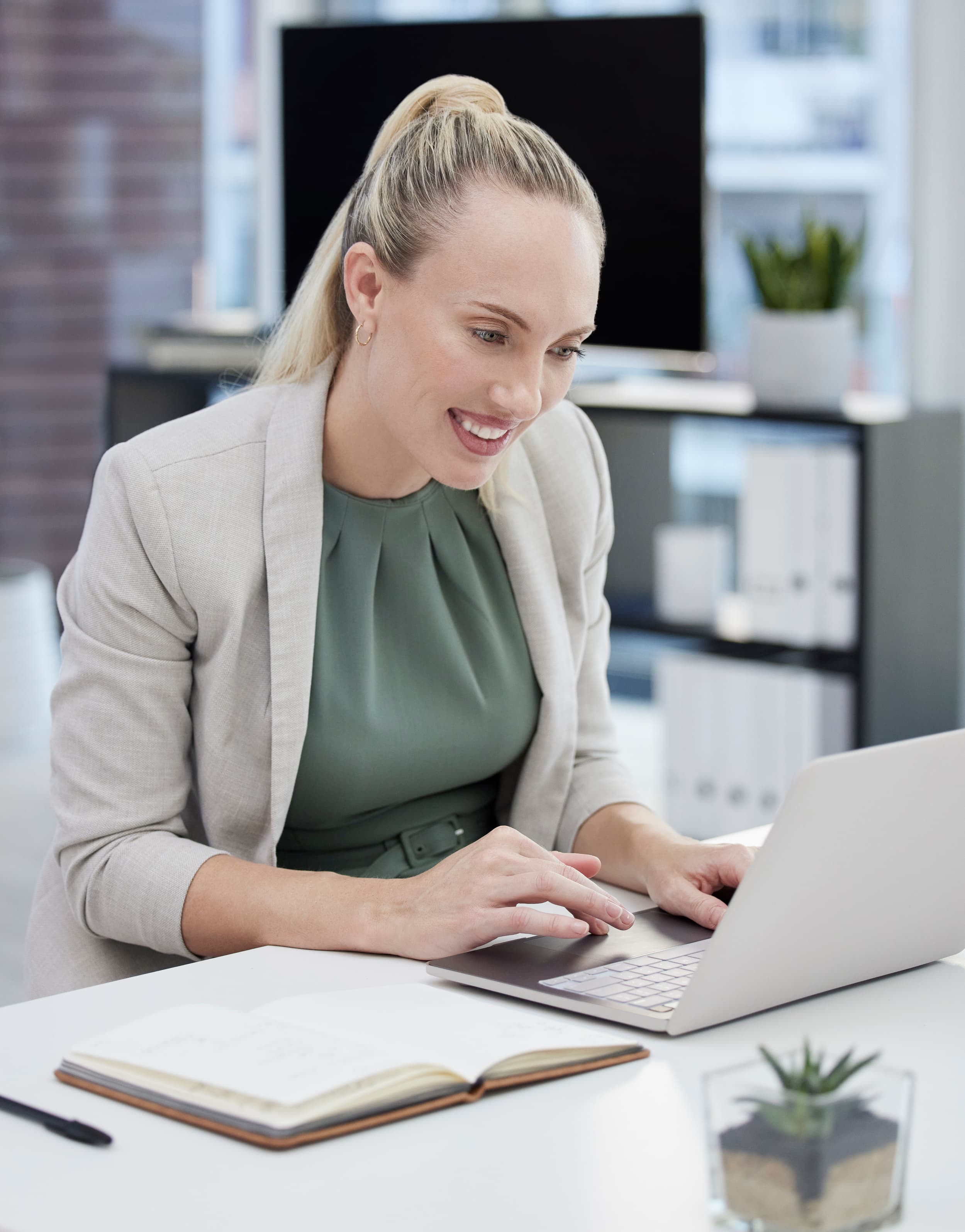 Young businesswoman working at her desk using a laptop